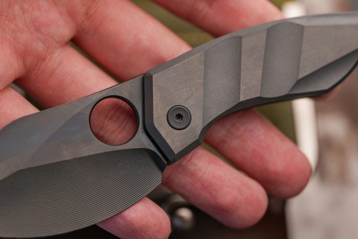 Representative compact tactical folding knife held in a hand