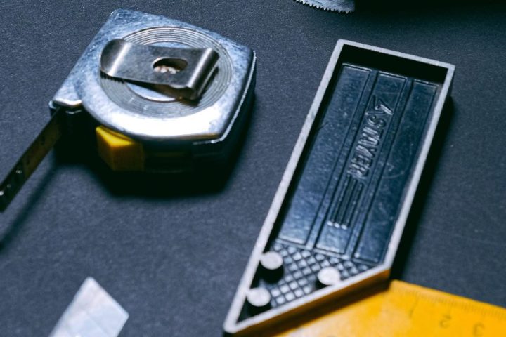 Utility knife and measuring tools arranged on a work surface